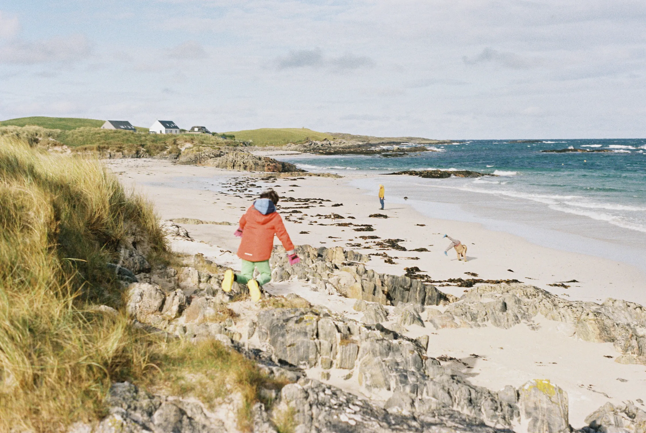 A child jumping down towards a beach