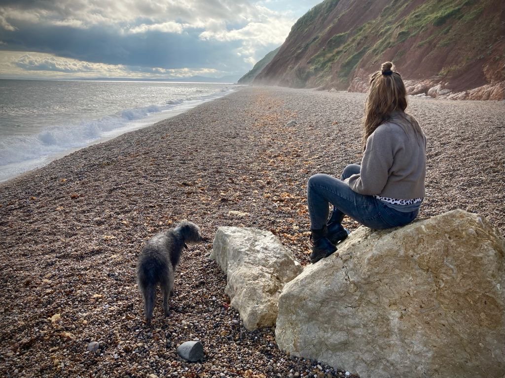   Sabrina, on the beach with her dog, Badger  
