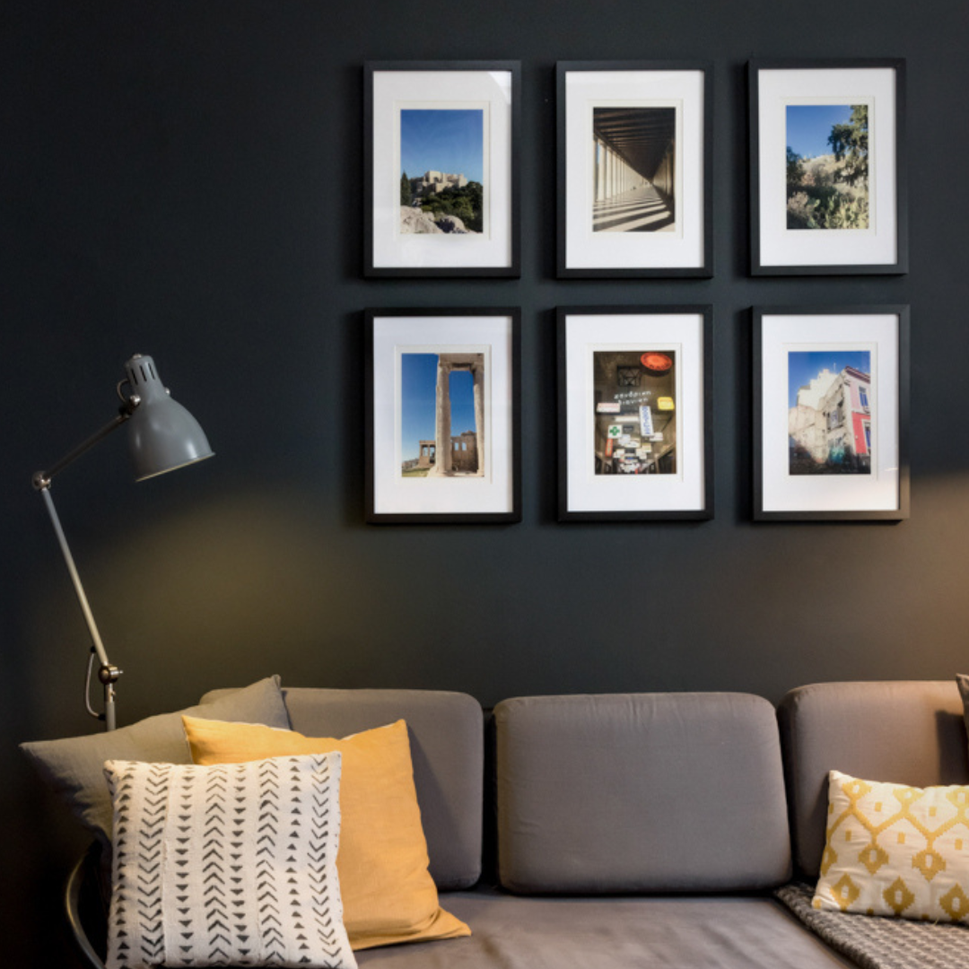 A group of framed photographs displayed together at home